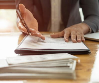 Close up business man reaching out sheet with contract agreement