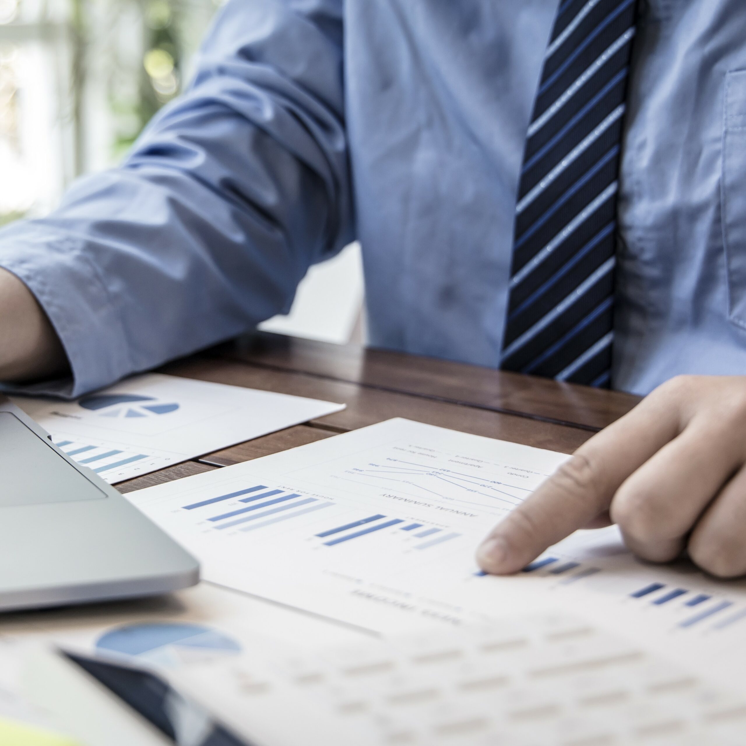 Financial businessmen use laptop to analyze marketing strategies
