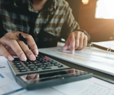 businessman working with calculator for financial document in of