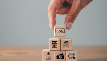 tax calculation concept, tax icon in the wooden cube for income tax return and submit tax for payment tax documents online to the government, Financial research.