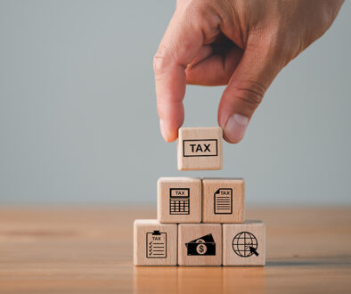 tax calculation concept, tax icon in the wooden cube for income tax return and submit tax for payment tax documents online to the government, Financial research.
