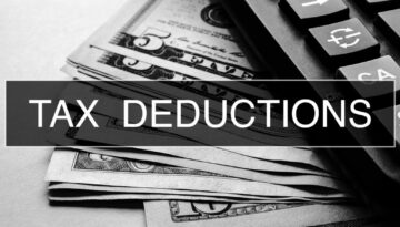 Tax Deductions Closeup Concept. Business. Tax Deductions text at Dollar Banknote.